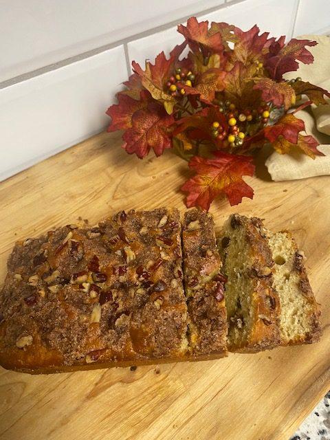 Chocolate milkshake in clear mug with whipped cream and Oreo cookie on top.