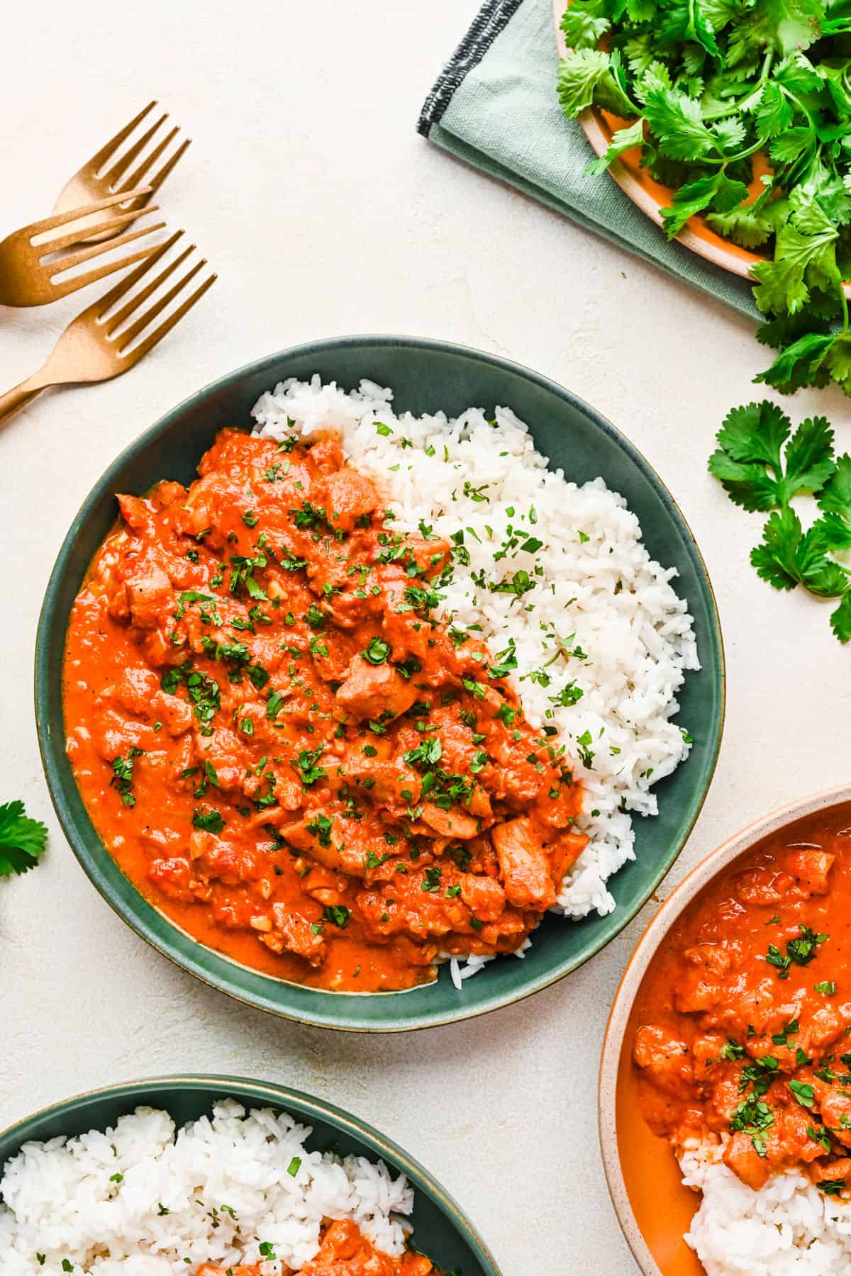 Three plates of Instant Pot Indian butter chicken and rice.