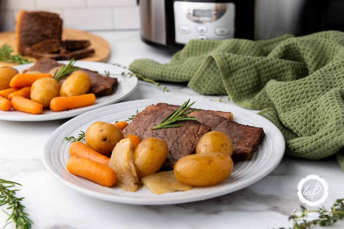 Rump roast and vegetables on a plate.