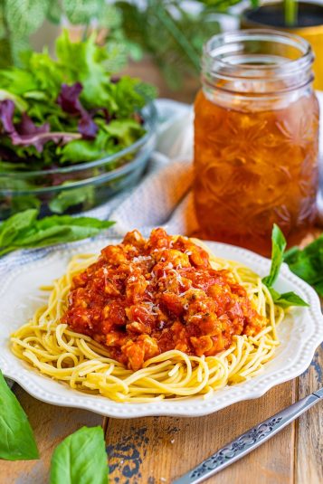 Turkey Spaghetti served on a white plate on a wooden table top.