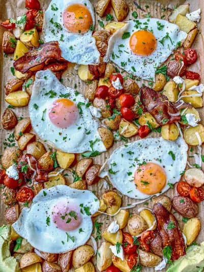Sheet pan breakfast hash including eggs, potatoes, bacon, avocado, and goat cheese.