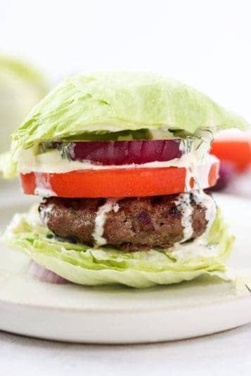A display of Greek Burgers with Tzatziki Sauce.