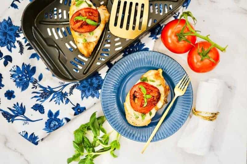 Fried chicken with mashed potatoes and green beans on a plate with a fork. 