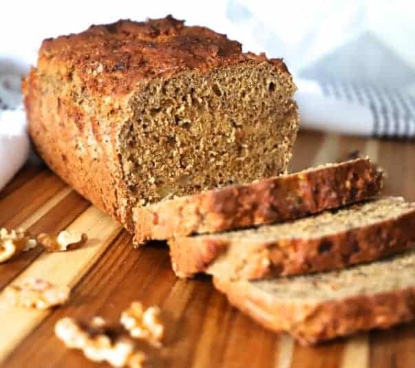 A sliced Cottage Cheese Banana Bread on a wooden board.