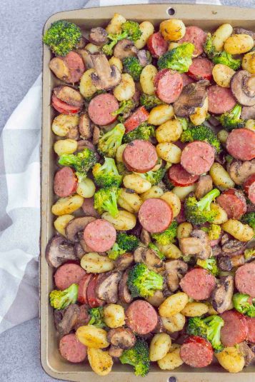 Sausage, gnocchi, broccoli and mushrooms on a sheet pan.