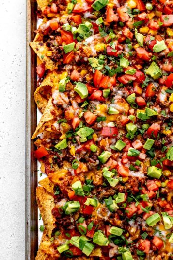 A birds-eye view of the epic beef nachos supreme on a foiled lined baking sheet.