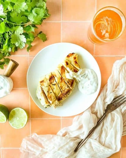A finished grinder sandwich is shown on a marble platter.