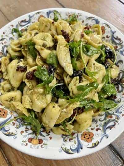 Finished pesto tortellini salad in decorative bowl.