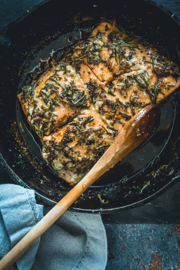 Osyter bake casserole on table with linen and herbs.
