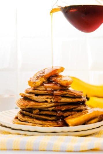Pancake stack picture with pouring maple syrup.