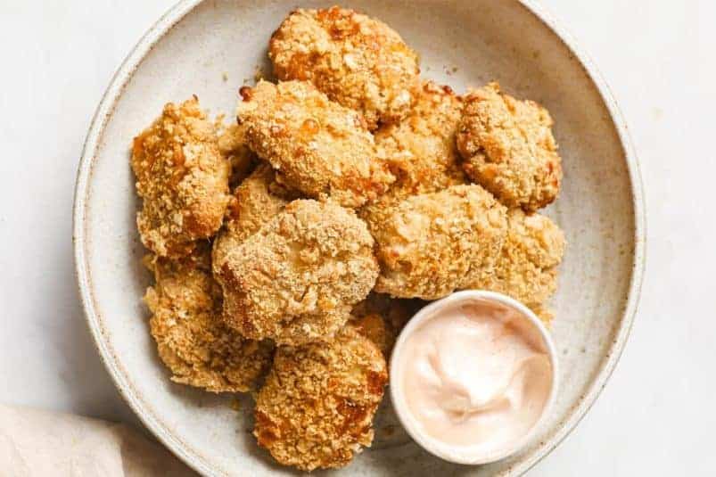 Chicken patties with broccoli on a plate.