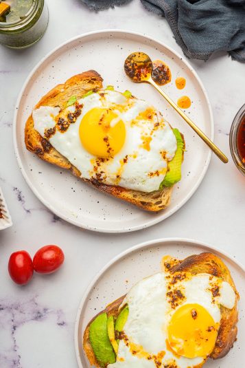 Over head image Avocado Toast with Egg on white plates.