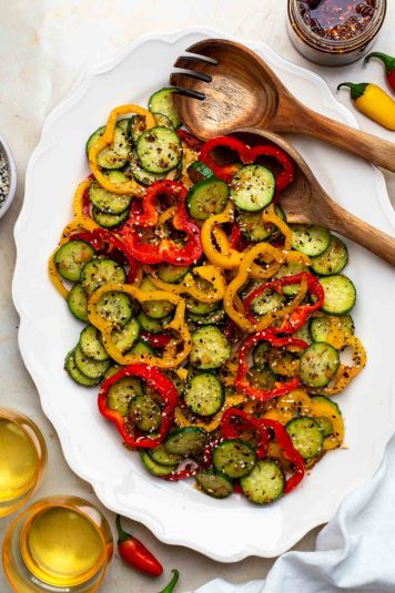 Bell pepper cucumber salad served on a white plate.
