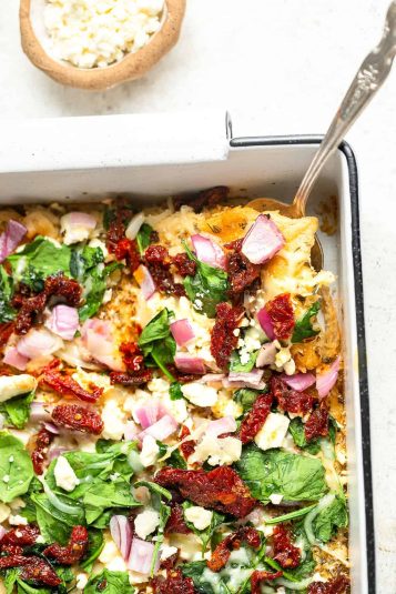 Mediterranean Egg White Pizza in a baking dish with a serving spoon.