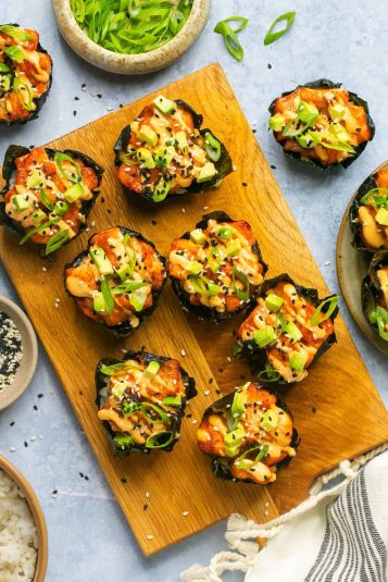 Baked salmon sushi cups on a cutting board.