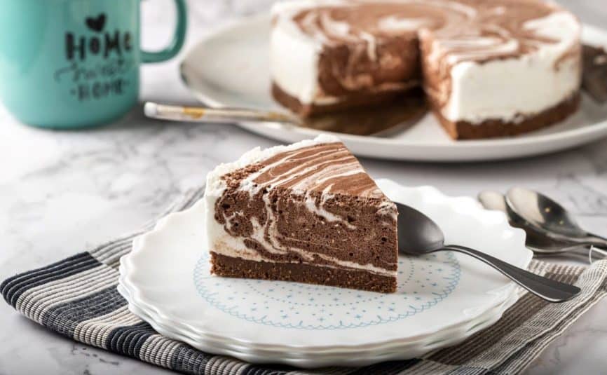 A slice of Zebra Cake on a plate.