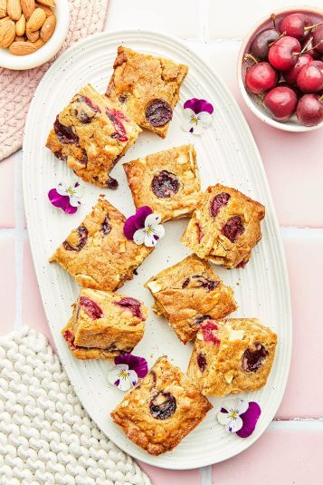 A platter with small squares of a cherry bar.