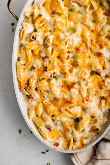 Baked crack chicken with golden gooey melted cheese on top in a large oval baking dish.