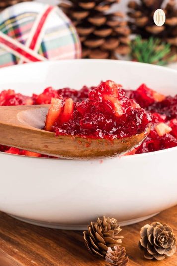 A scoop of jello mixture using a wooden spoon.