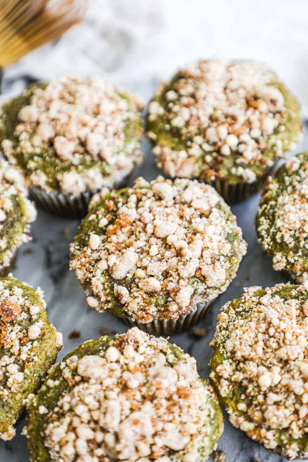Matcha cinnamon streusel muffins with crumbly streusel and matcha vanilla bean glaze.