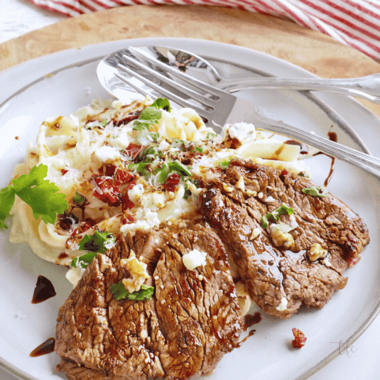 Olive Garden Steak Alfredo with fettuccine and balsamic drizzle.