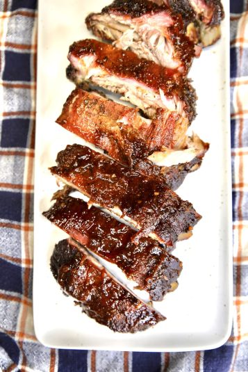 Platter of sliced bbq baby back ribs.