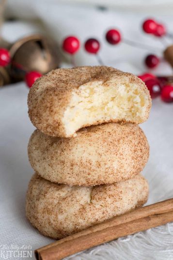 Cinnamon Cream Cheese Cookies stacked with bite taken out of top cookie.