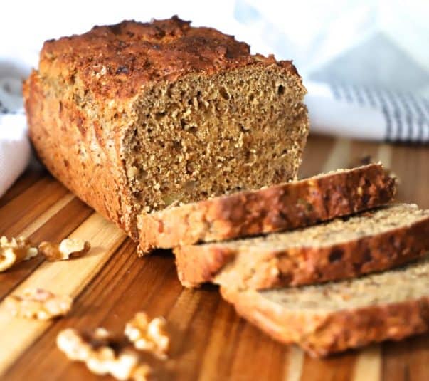 A sliced Cottage Cheese Banana Bread on a wooden board.