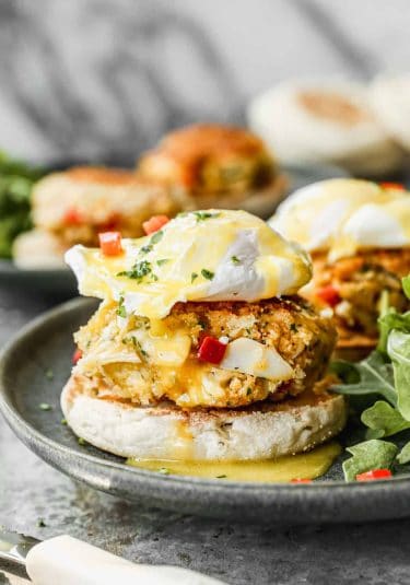 Crab Cake Benedict on a plate with homemade hollandaise sauce on top.