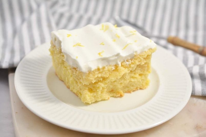A bundt cake on a plate with a slice taken out.