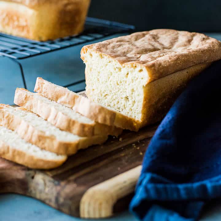 A loaf of homemade English muffin bread on a blue background.