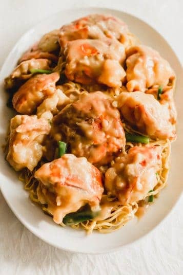 Lobster yee mein on a white oval plate.
