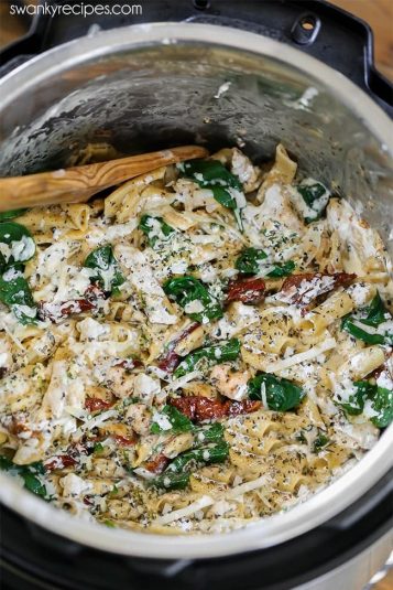 Instant Pot Chicken Pasta. Creamy Tuscan pasta with chicken breasts, pasta noodles, cheese, and herbs.