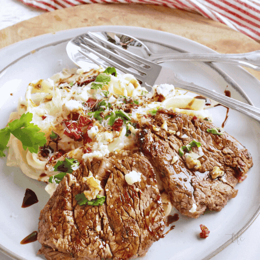 Olive Garden Steak Alfredo with fettuccine and balsamic drizzle.