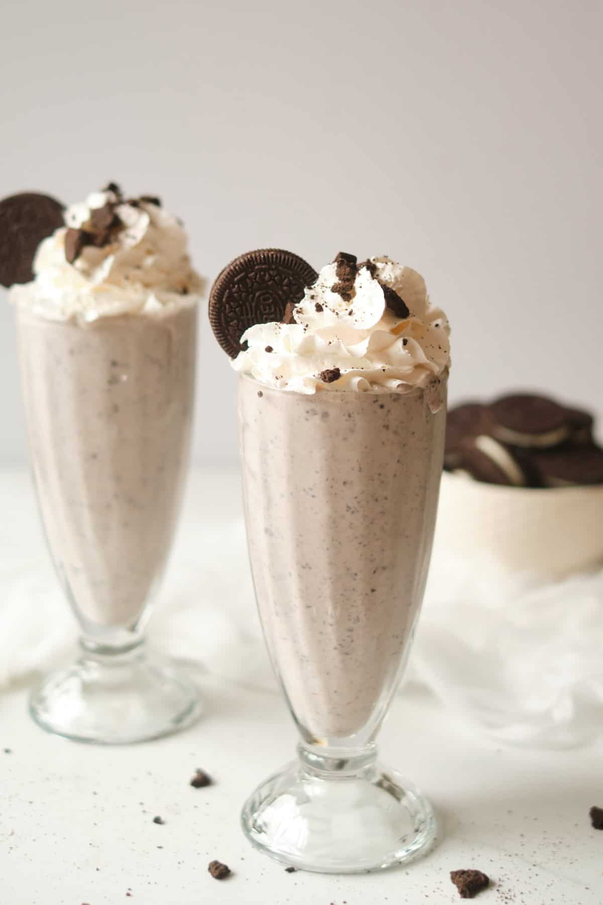 Two glasses filled with oreo milkshake.
