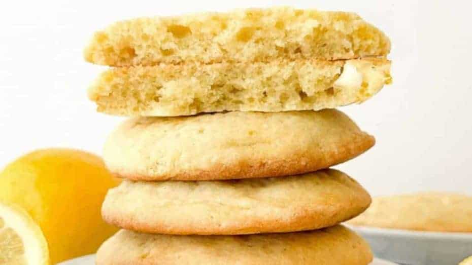A tall stack of Panera lemon drop cookies on a white plate.