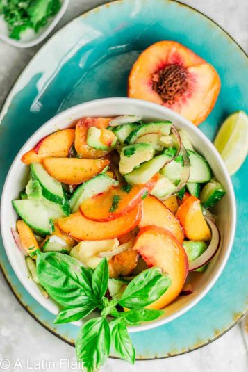 Peach avocado salad served on blue plate.