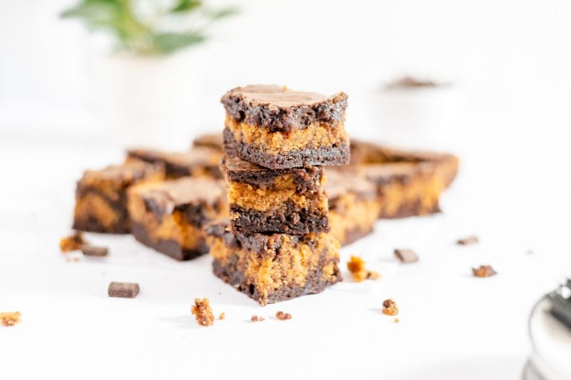 Layered Buckeye Brownies stacked up with more brownies around them.