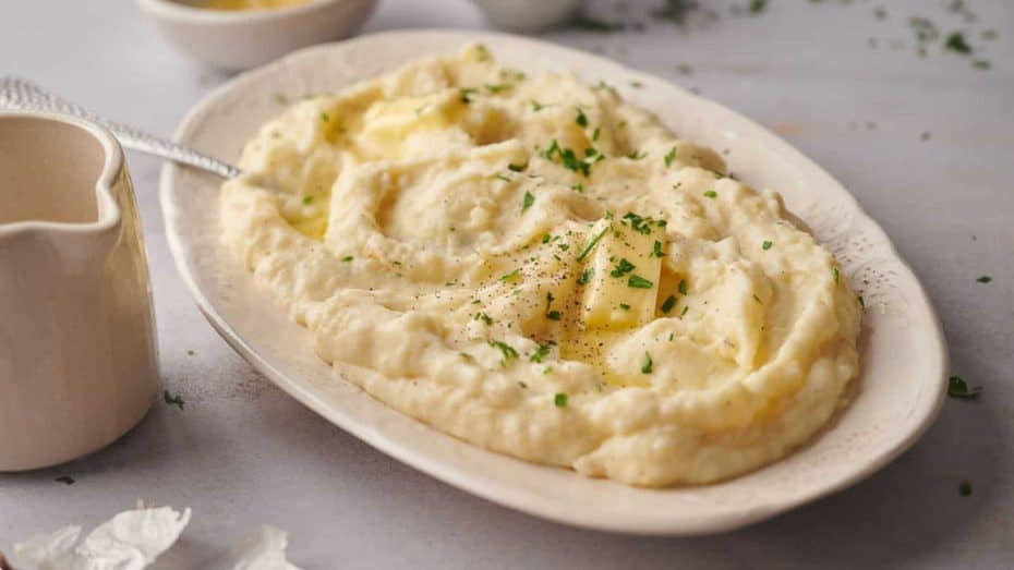 A white dish with green bean casserole in it.