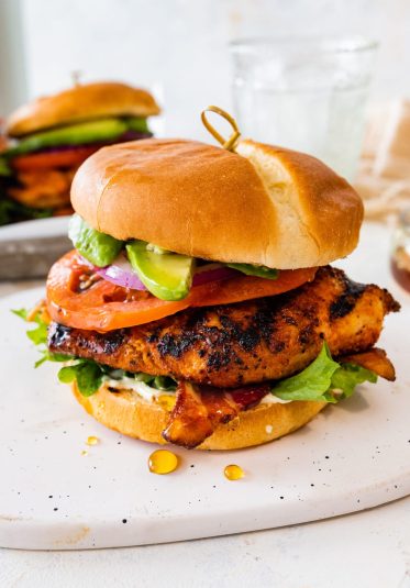 Ultimate grilled chicken sandwiches on a tray with parchment paper. Mouthwatering!