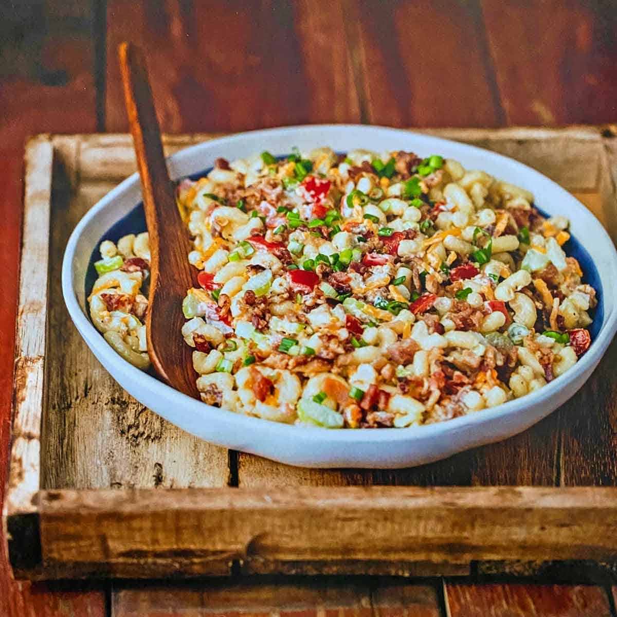 Bacon macaroni salad in a large white bowl.