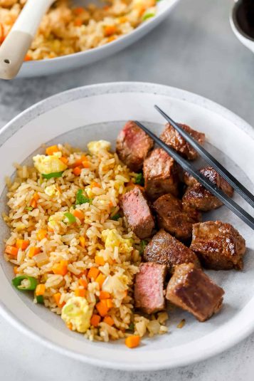 Cooked hibachi steak served in a bowl with hibachi fried rice.