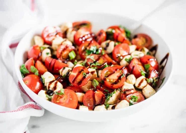 Caprese salad in white bowl.