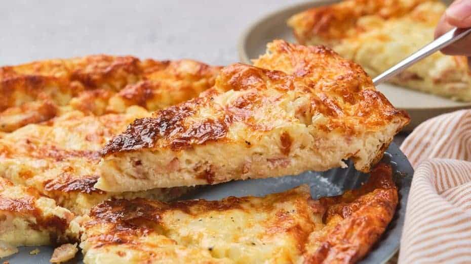 Close-up of crispy, cooked maple bacon slices in a white dish.