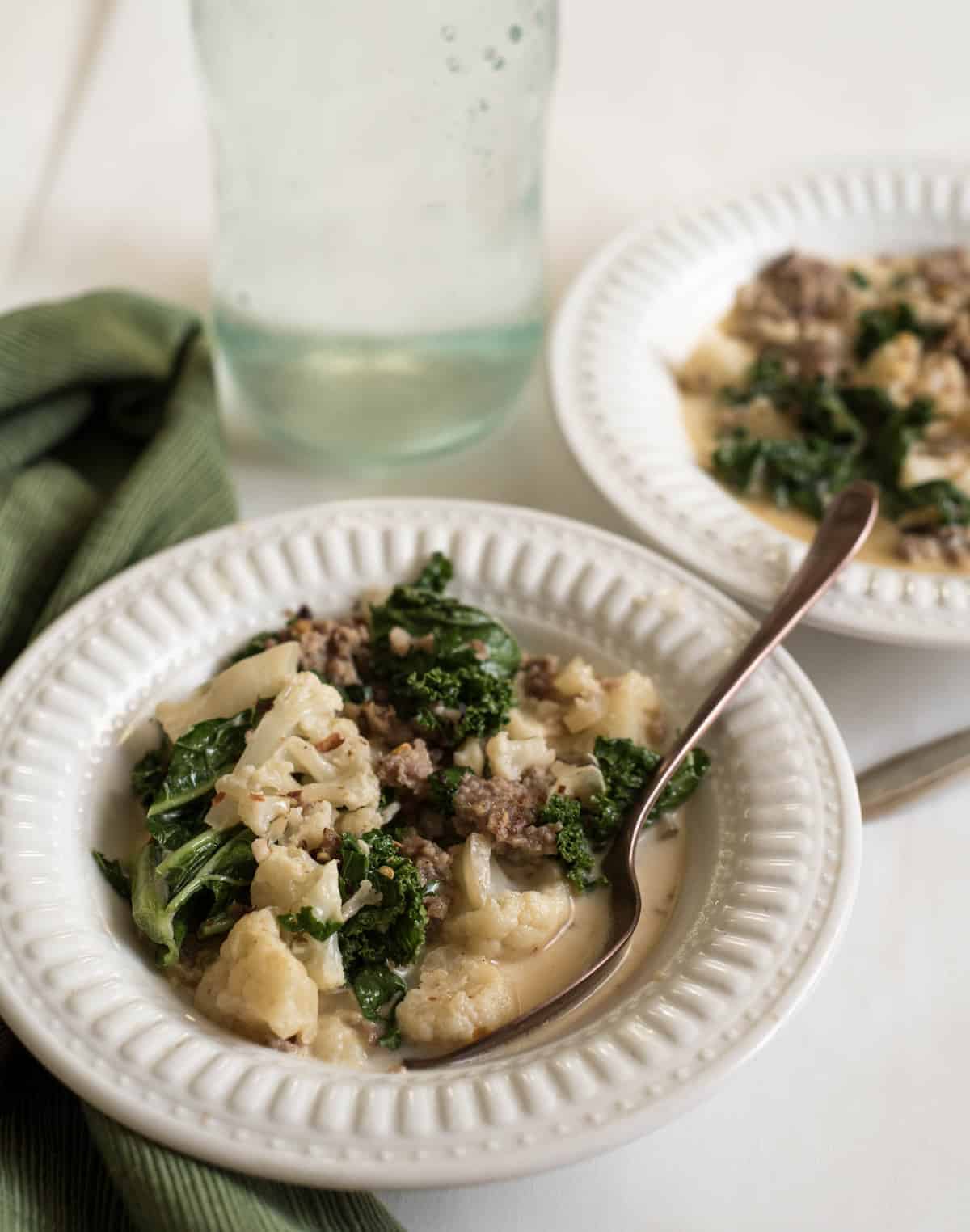 A bowl of Cauliflower Sausage and Kale Soup.