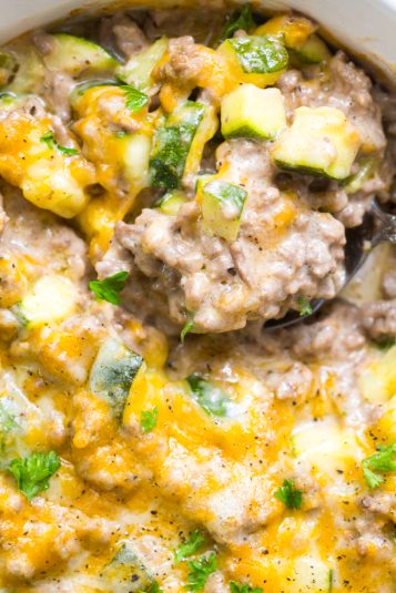 Keto Zucchini with Ground Beef in a casserole dish with a spoon.