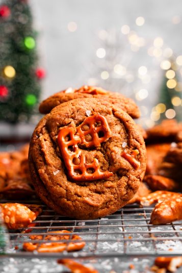 A close up of the peanut butter pretzel cookies with peanut butter nuggets and pretzels around it.