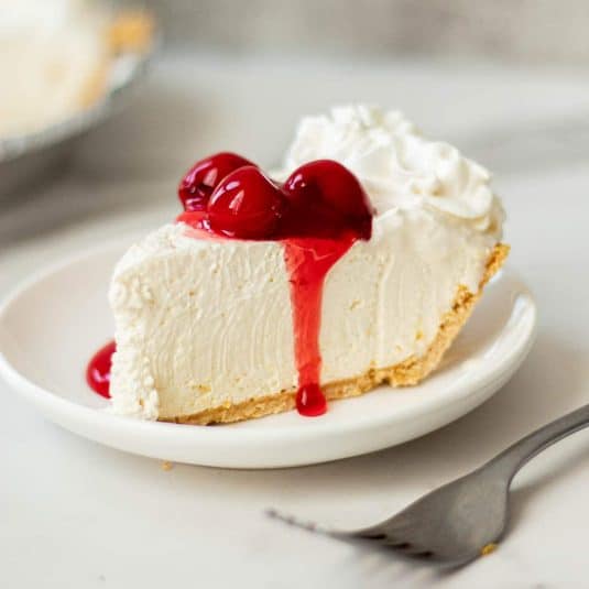 A slice of philadelphia no bake cheesecake with cool whip.