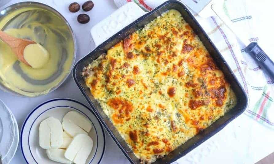 Low carb protein lasagna on a white dish with a fork.