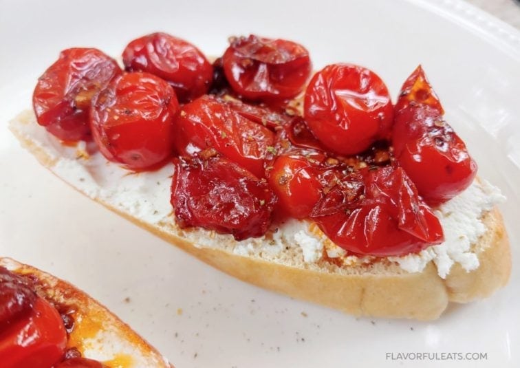 Close up shot of Goat Cheese Crostini with Balsamic Grape Tomatoes.